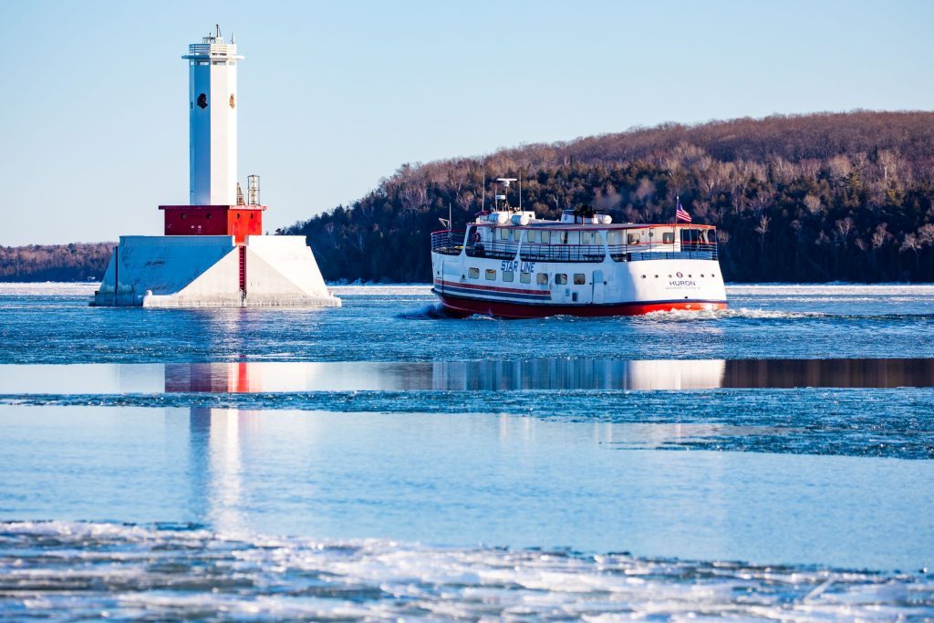 AStar Line, now known as Mackinac Island Ferry Company boat makes its way through the ice to Mackinac Island on a sunny winter day