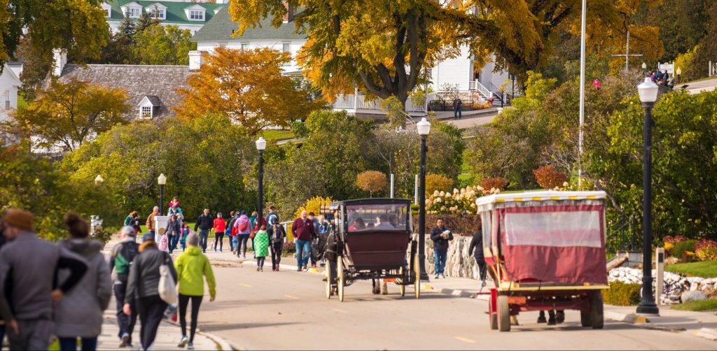 Fall on Mackinac Island brings cooler weather and glorious fall colors as visitors wear sweatshirts and jackets.