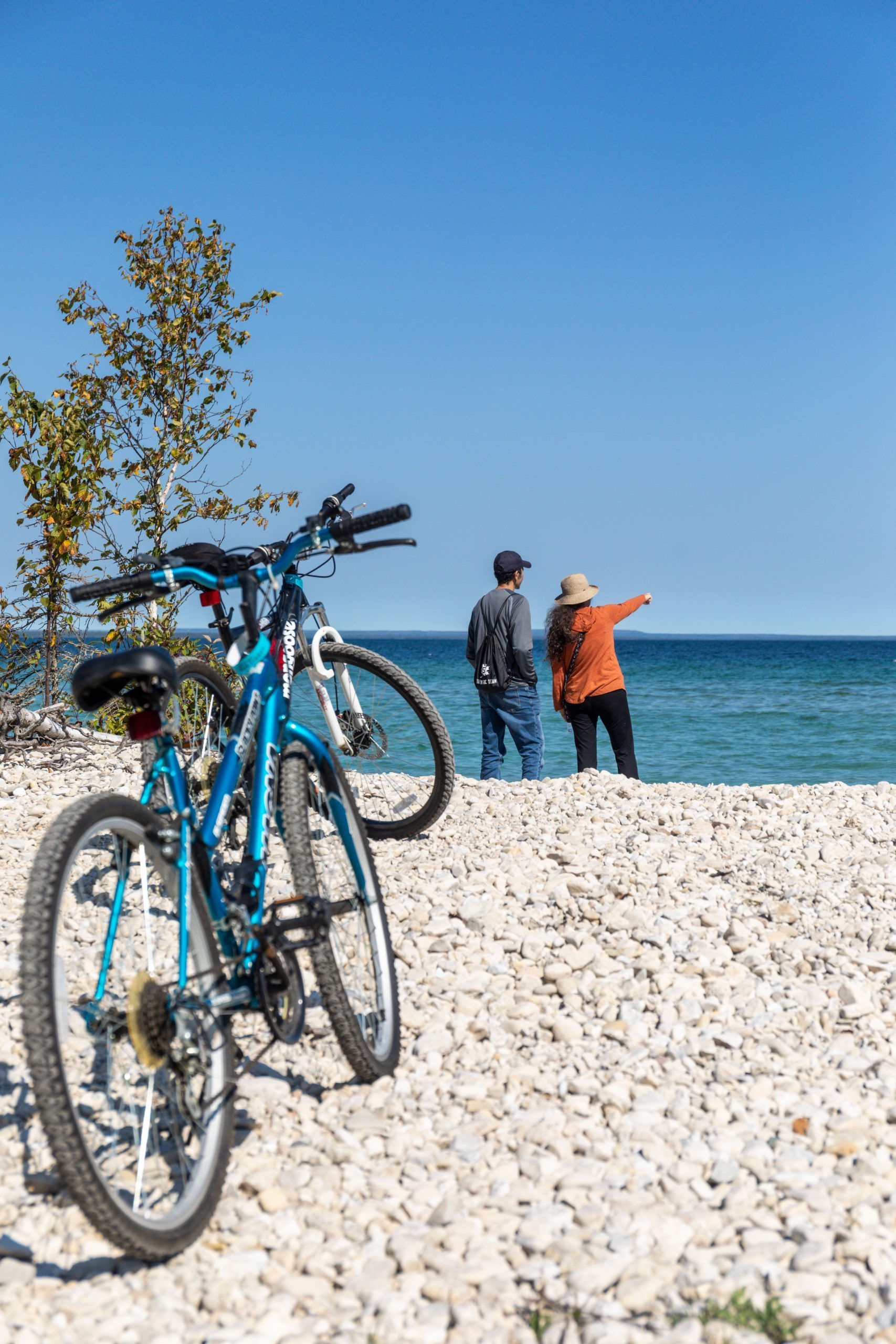Bicycle riders on Mackinac Island take a break from pedaling to enjoy the beauty of the lakeshore.