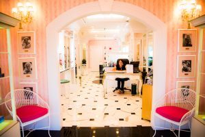 A professional stylist sits behind the front counter in the colorful Astor’s Salon and Spa at Mackinac Island’s Grand Hotel.