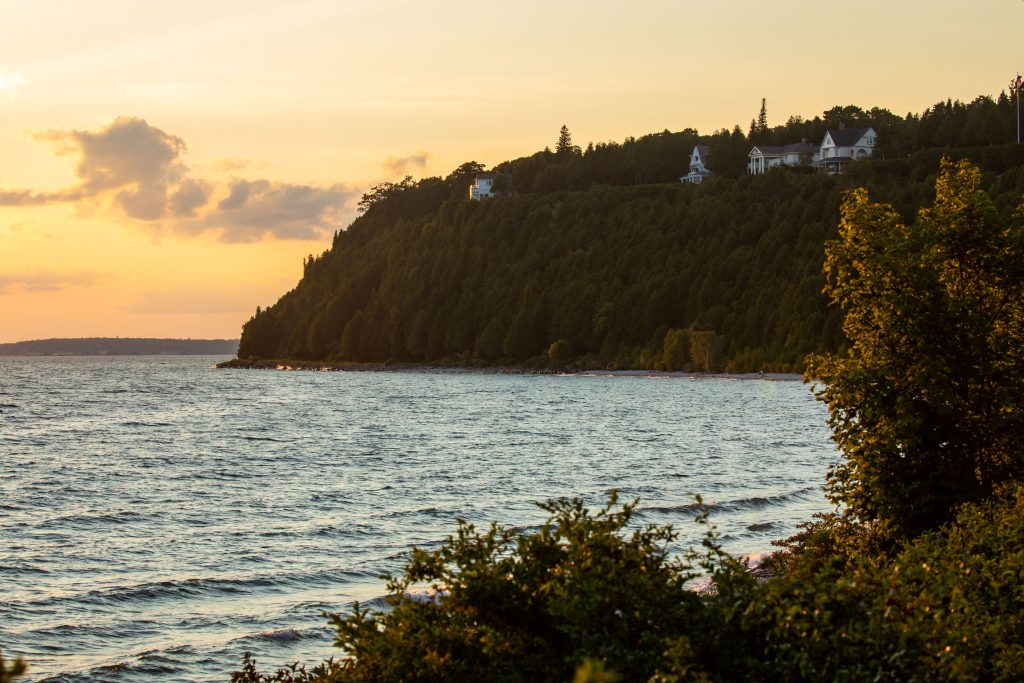 Homes and cottages sit high on Mackinac Island’s West Bluff at sunset