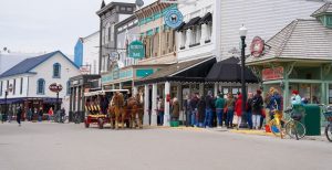 Mackinac Island visitors line up for a horse-drawn ride to many sights and landmarks with Mackinac Island Carriage Tours.