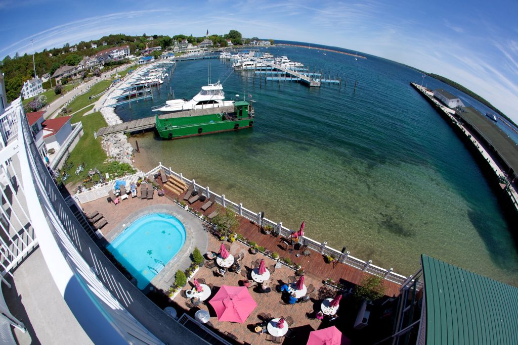 A balcony view from Mackinac Island’s Chippewa Hotel encompasses the marina, a ferry dock and a swimming pool