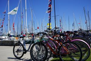 Row of Bikes Parked Alongside Dock Where Sailboats Wait on Mackinac Island