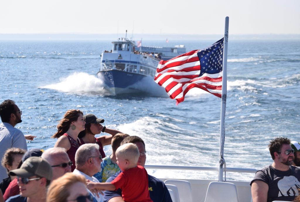 An American flag waves in the breeze off the back of a Mackinac Island ferry boat