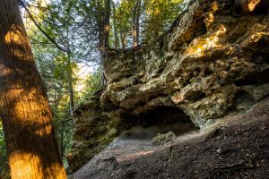 Eagle Point Cave in the woods of Mackinac Island State Park is accessible from above and below