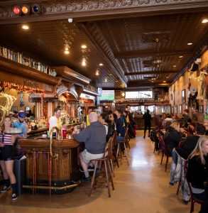 Mackinac Island visitors fill the dining tables and bar seats at Horn's Bar