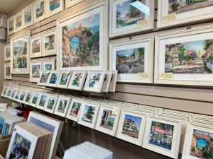 Framed paintings of Mackinac Island scenes line the walls of Island Breeze Fine Art & Gifts art gallery