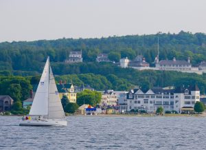 White Sailboat Cruising in the Waters Within View of Shore on Mackinac Island