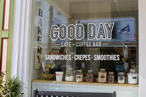 The front window of Good Day Cafe and Coffee Bar on Mackinac Island touts sandwiches, crepes and smoothies