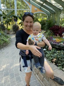 A woman and child enjoy an up-close encounter with a butterfly at the Wings of Mackinac conservatory on Mackinac Island.