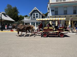 A horse-drawn taxi transports passengers down Mackinac Island’s Main Street.