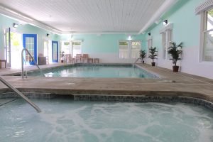 A heated indoor swimming pool at Mackinac Island’s Island House Hotel accompanies a sauna and hot tubs indoors and outdoors.