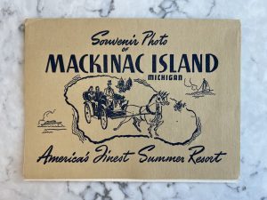 An old souvenir photo holder touts Mackinac Island as "America's Finest Summer Resort"