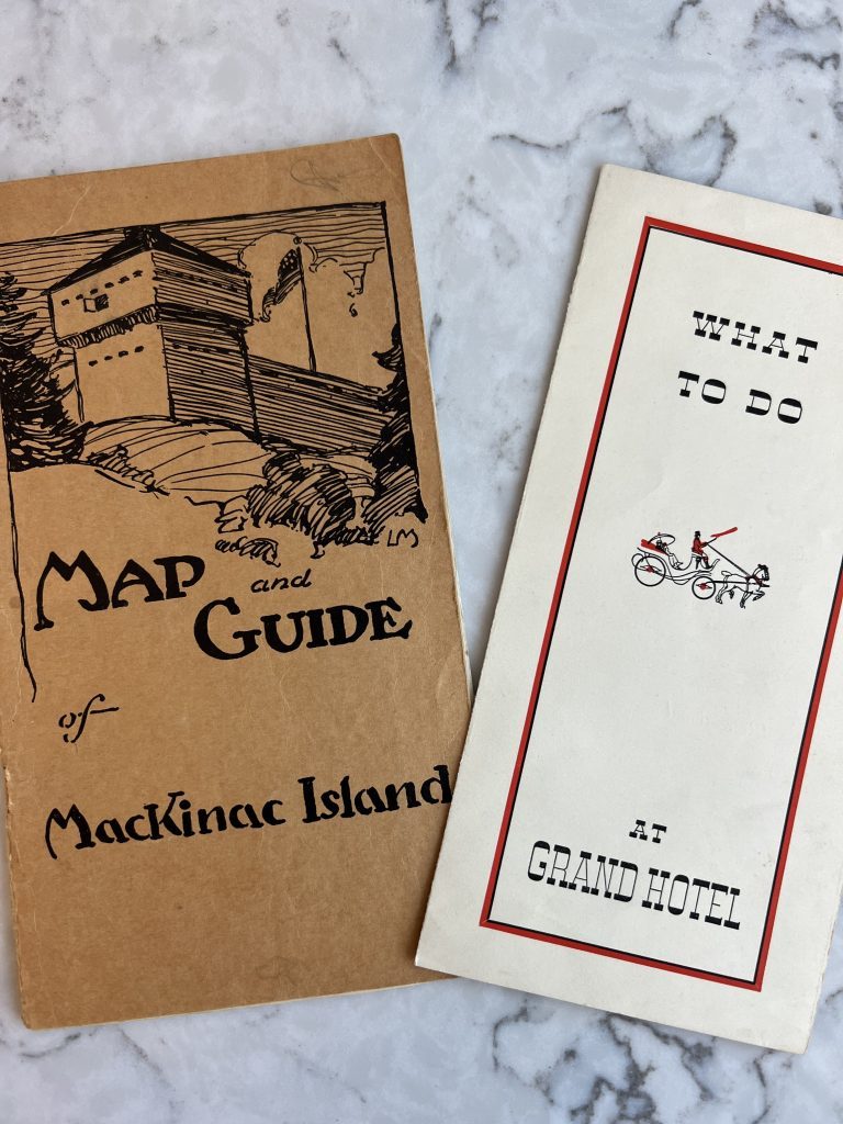 An old map and guide of Mackinac Island with a brochure of things to do at Grand Hotel