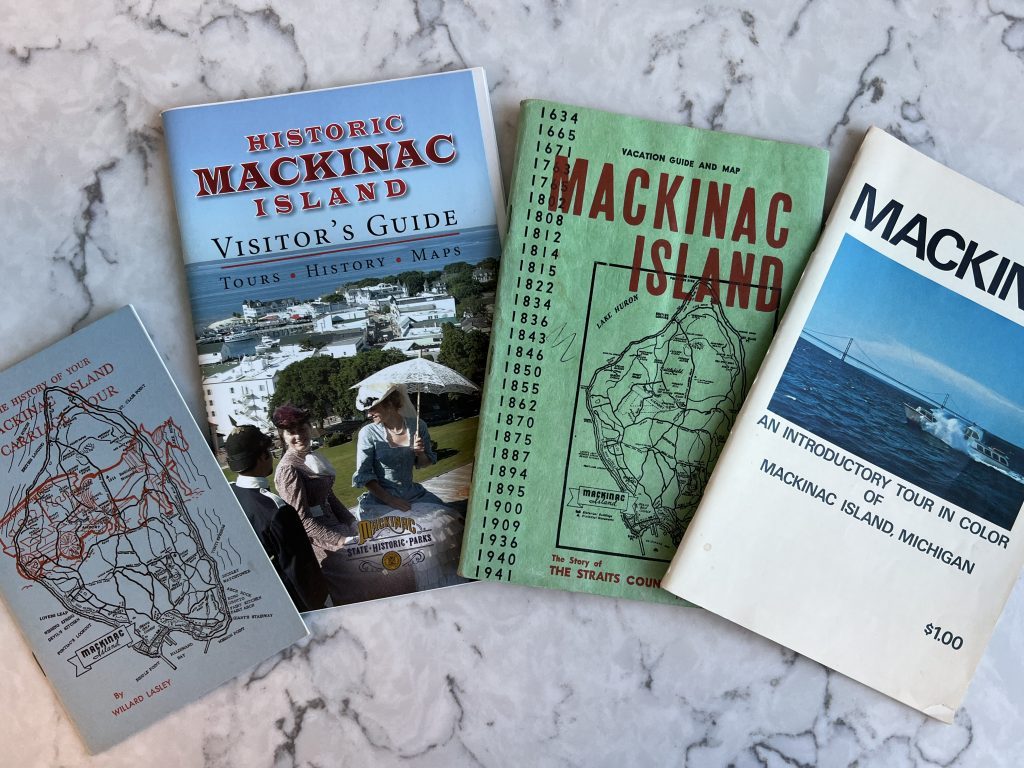 A collection of old Mackinac Island maps and visitors guides