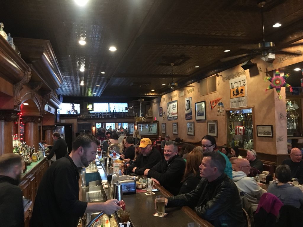 Customers sit at the bar inside Horn’s Gaslight Bar on Mackinac Island