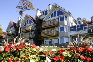 Multiple levels of decks and large windows shape the water-facing exterior of LakeBluff Condos & Suites on Mackinac Island