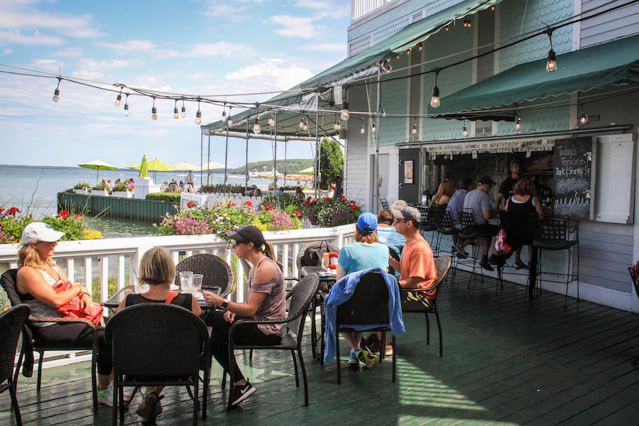 People dine outdoors on the patio at Mary's Bistro Draught House on Mackinac Island