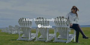 An image of a woman sitting on an Adirondack chair on the lawn at Mackinac Island's Mission Point Resort with the words "A Most Tourist Friendly U.S. City - Expedia" over top