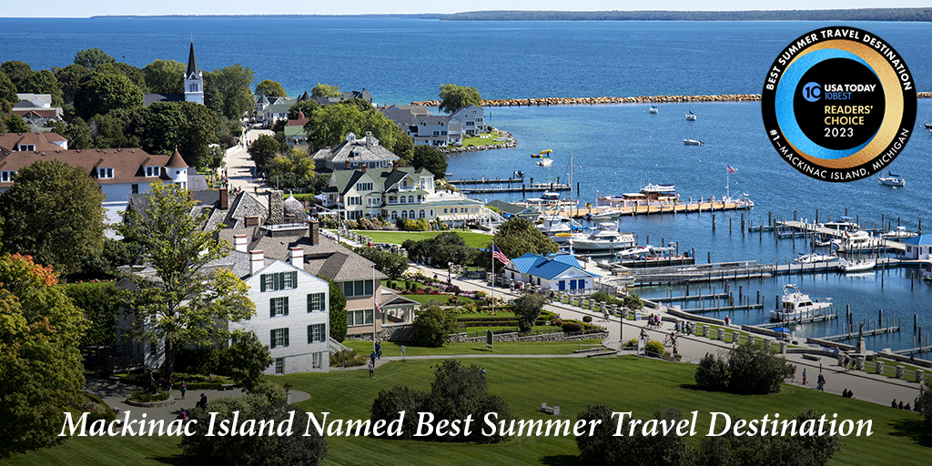 An eastward view down Mackinac Island's Main Street with the words "Mackinac Island Named Best Summer Travel Destination"