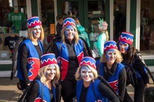 A group of women dressed in Halloween costumes smiles for the camera on Mackinac Island
