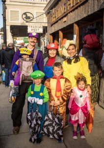 A family dressed as Ninento video game characters poses for a photo during Mackinac Island's Halloween Weekend