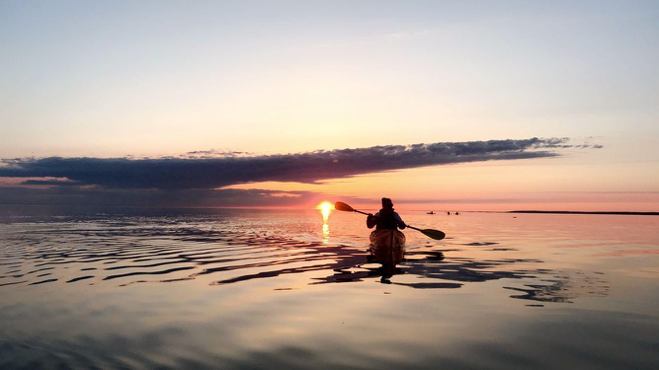 The Mackinac Bridge at sunset is one of many spectacular sights to see on a kayak tour around Mackinac Island.