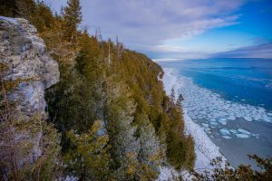 Ice floats in the water off Mackinac Island as seen from the bluffs high above