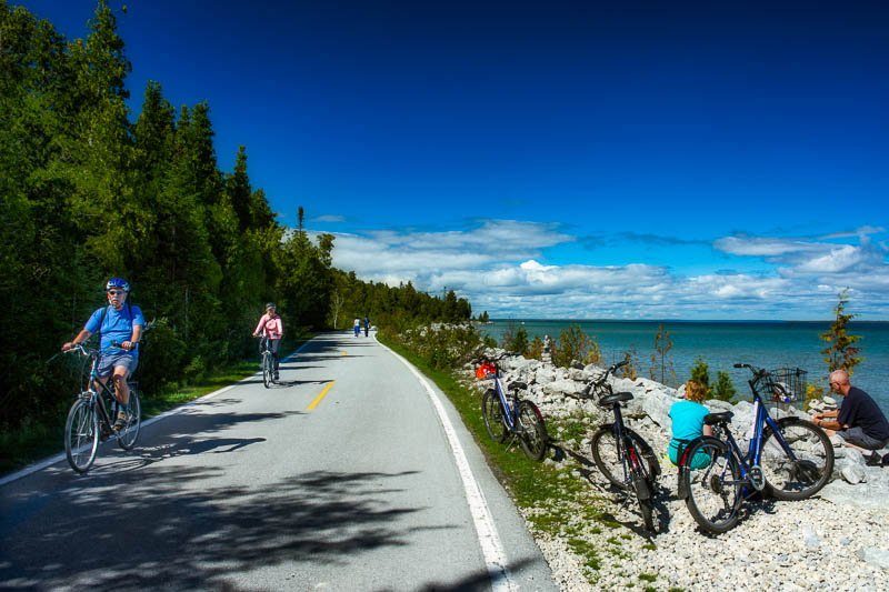 Riding a bicycle around the perimeter of Mackinac Island on M-185 is one of many iconic things to do on Mackinac Island. 