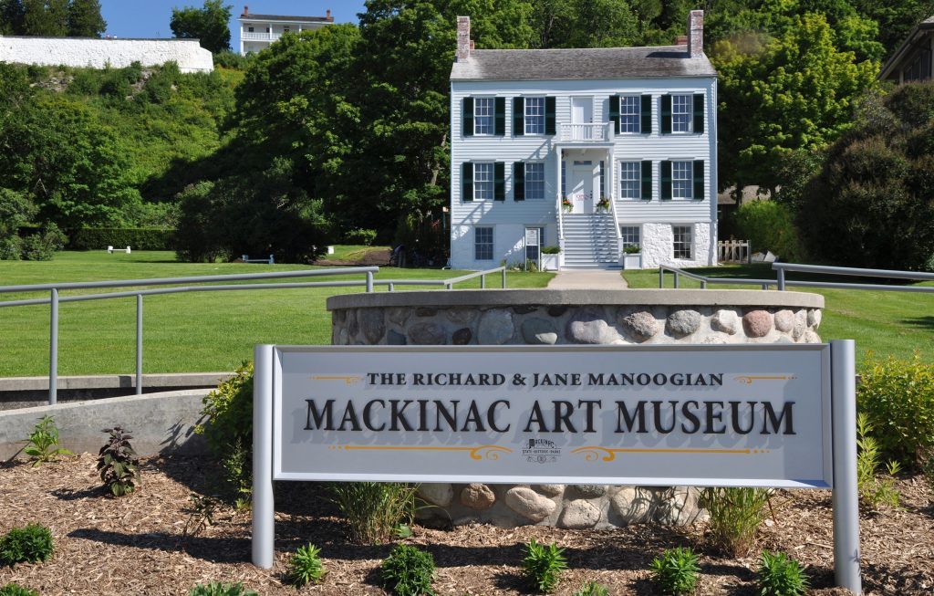 A sign identifies the former Indian Dormitory on Mackinac Island as the Richard & Jane Manoogian Mackinac Art Museum