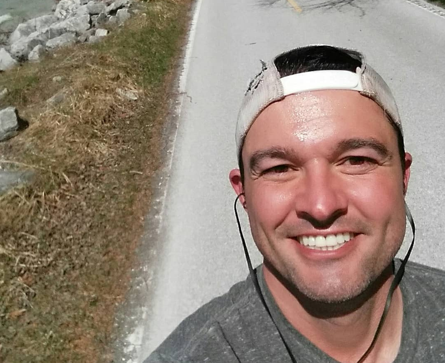 A man takes a break from running around Mackinac Island’s Lake Shore Drive to snap a selfie.