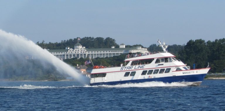 Star Line Mackinac Island Ferry rides past Grand Hotel while transporting passengers from the mainland.