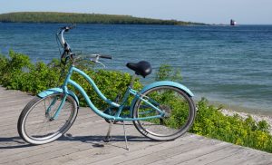 A bicycle stands on the Mackinac Island boardwalk along the waterfront