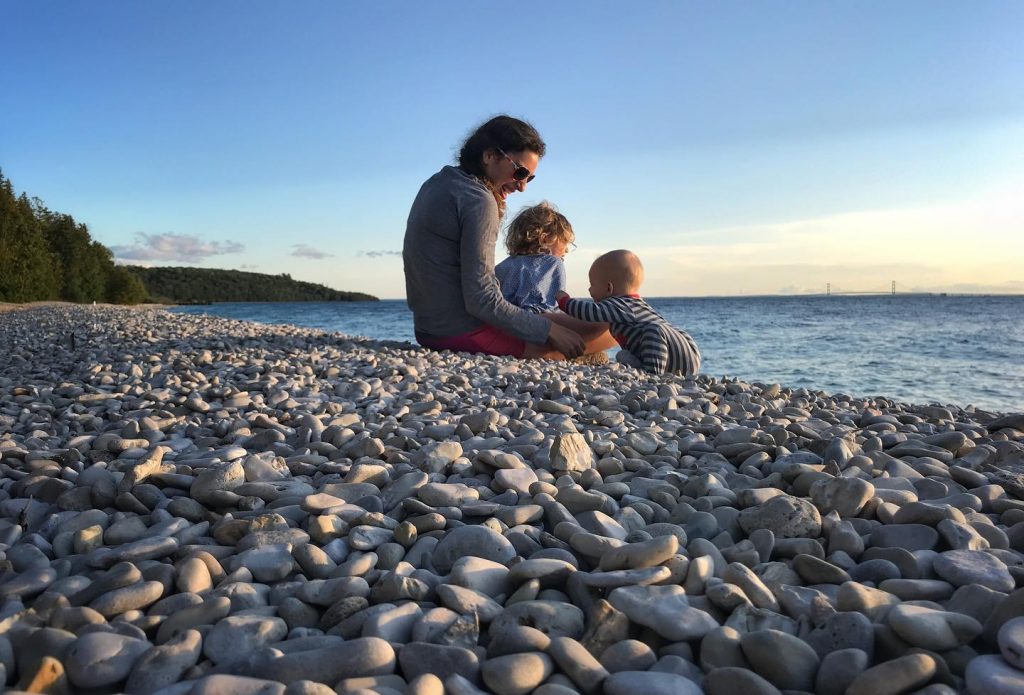 Mother and Two Sons Sitting on Rocky Shore of Mackinac Island