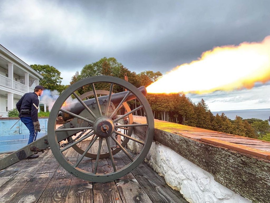 Fire blasts from a cannon at Mackinac Island’s historic Fort Mackinac