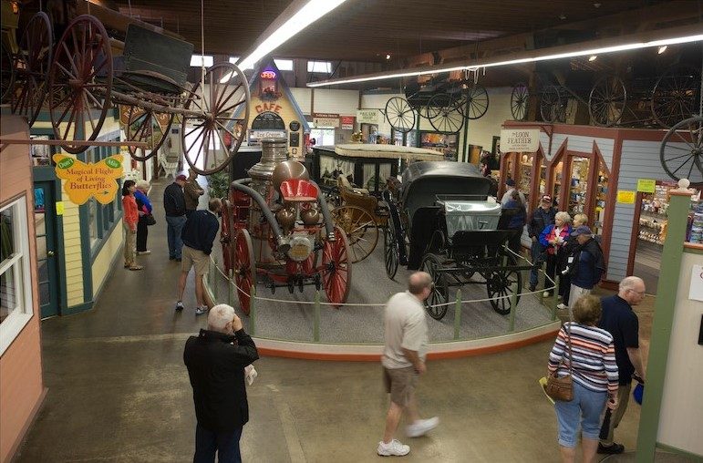 Mackinac Island visitors explore the history of horse-drawn transportation at the Surrey Hill Carriage Museum.
