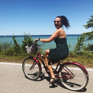 Woman Riding Bike – Mackinac Island Tourism Bureau