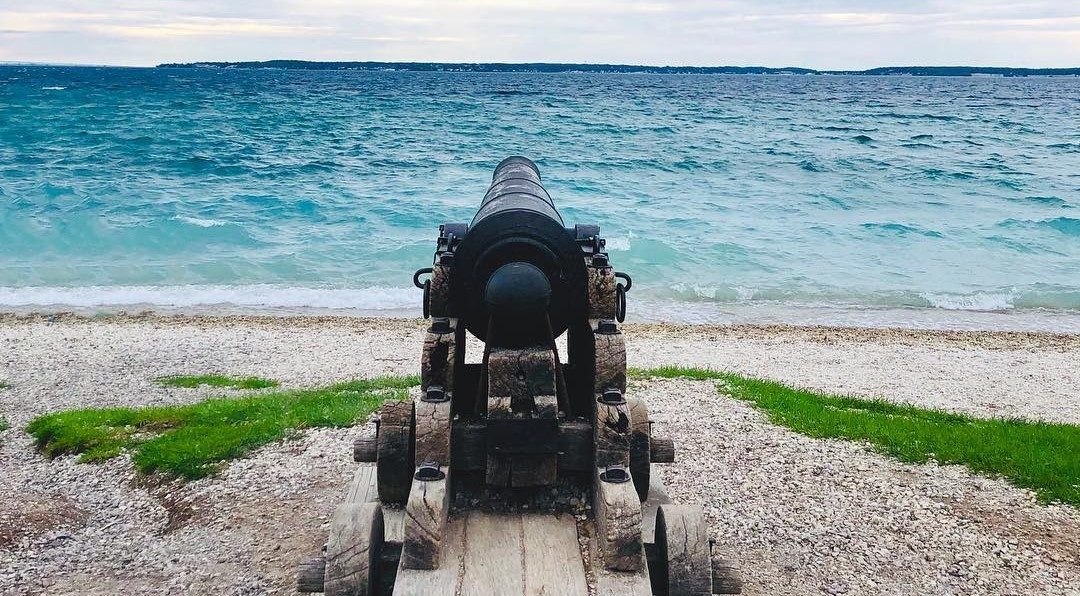 A lone cannon points out over Lake Huron from Mackinac Island’s British Landing toward Michigan’s Upper Peninsula