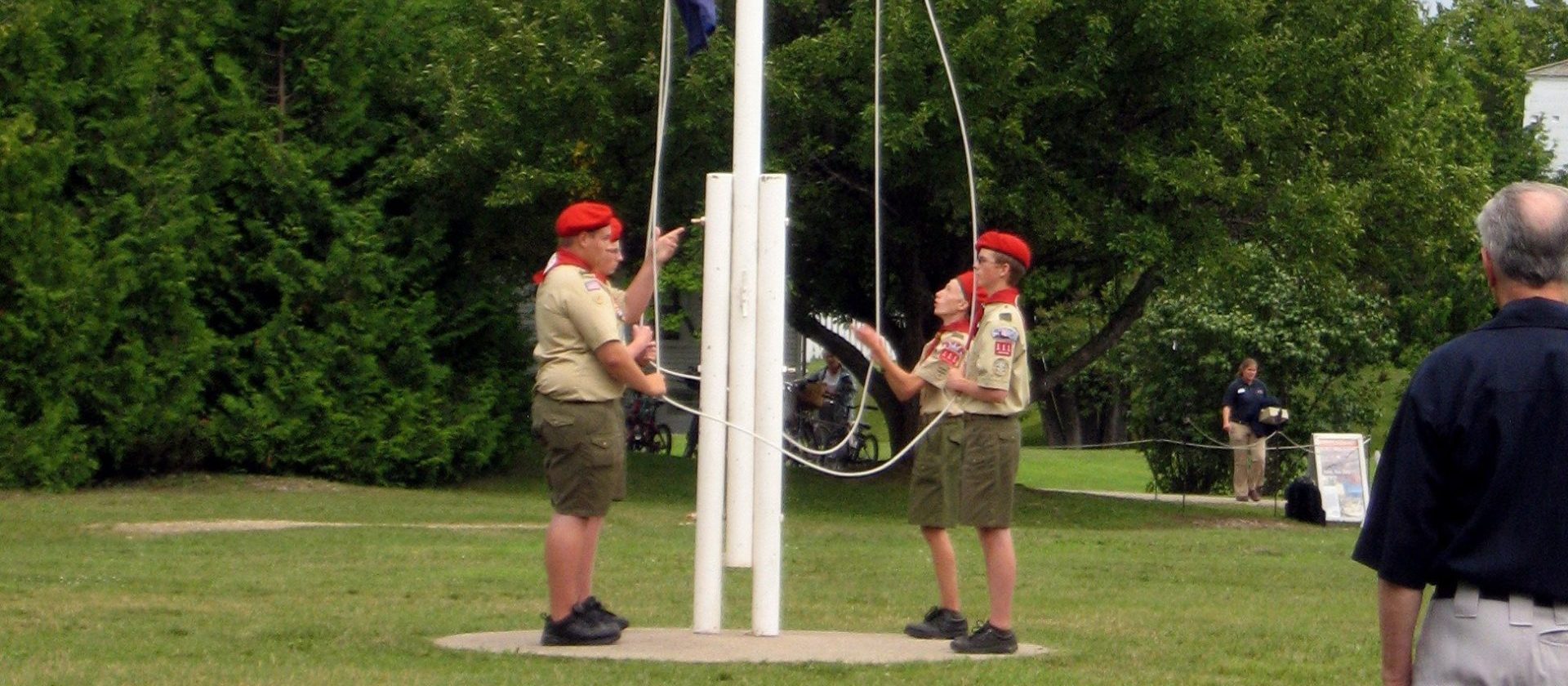 Boy Scouts raise an American flag up the flagpole on Michigan's Mackinac Island