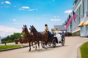 Newly-Wed Couple Riding in Horse-Drawn Carriage Outside Grand Hotel on Mackinac Island