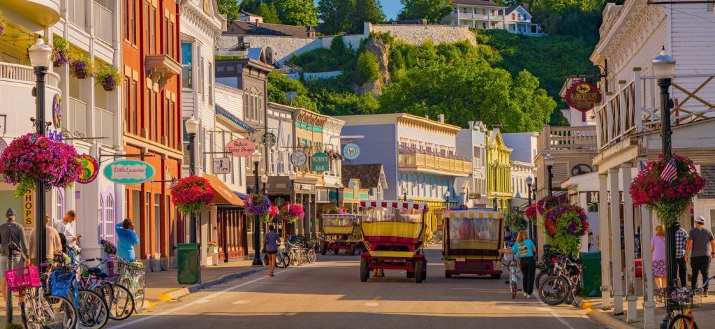 Horse-drawn taxis fill Main Street on a sunny summer day in downtown Mackinac Island