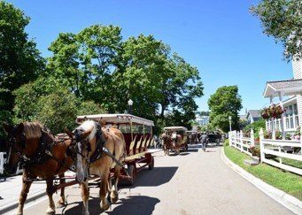 Horse-Drawn Carriages on Road Outside Cloghaun Bed & Breakfast on Mackinac Island