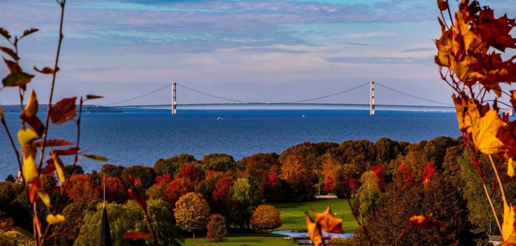 Mackinac Island is especially beautiful in the fall with colorful leaves set against blue waters and the Mackinac Bridge.