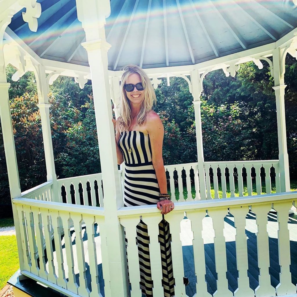 Woman in Sunglasses Posing for Photo in Somewhere in Time Gazebo on Mackinac Island