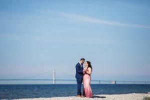 Couple Preparing to Reaffirm Their Marriage Vows Posing for Photo in Front of Shore on Mackinac Island