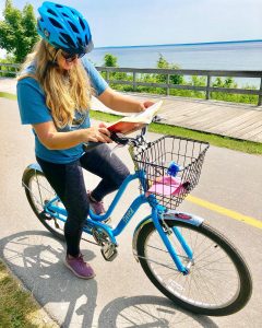 Reading and riding a bicycle on Michigan’s Mackinac Island is possible, if not encouraged.