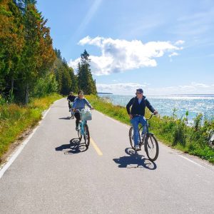 Riding a bicycle around the perimeter of Mackinac Island on M-185 is a popular activity for visitors.