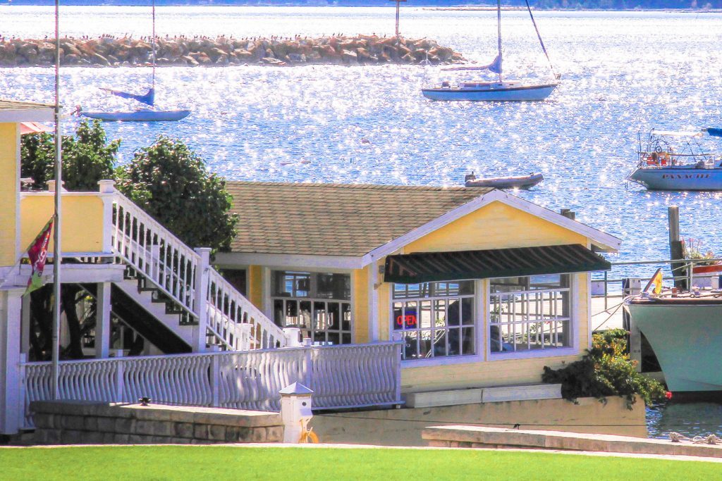 Watercolor Cafe is in a yellow building along the Mackinac Island harbor by Bay View Inn