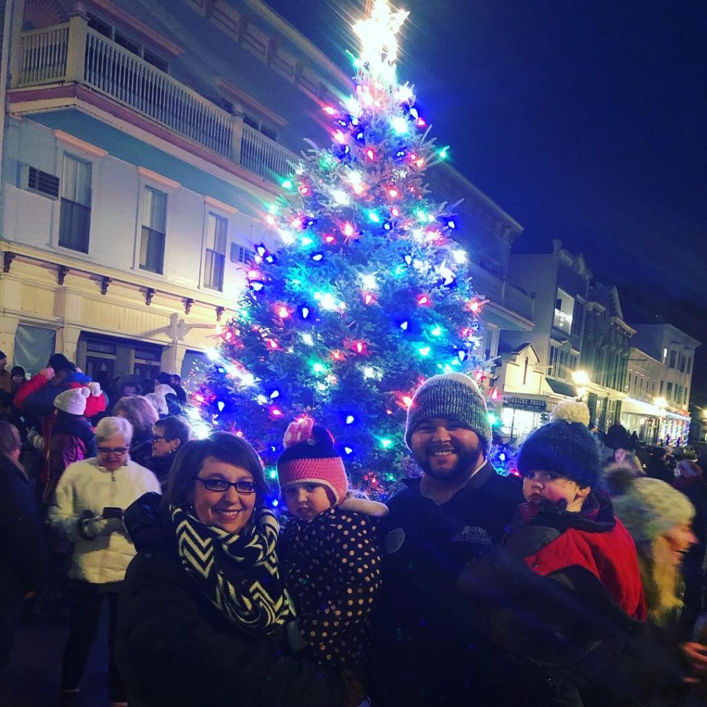 Visitors to Mackinac Island Posing for Photo in Front of Christmas Tree 